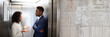 © Andrey Popov - Businesspeople Having Conversation In Elevator