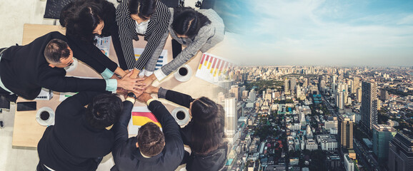 Wall Mural - Happy business people celebrate teamwork success together with joy at office table shot from top view . Young businessman and businesswoman workers express cheerful victory in broaden view .