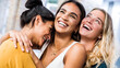 © Davide Angelini - Three happy women smiling together outdoors - Multicultural girls having fun on city street - Happy friendship concept with females enjoying day out