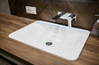 new clean white washbasin with water tap in the bathroom
