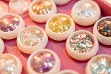 Multi-colored Tubes With Sequins For Makeup.