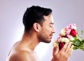 Canvas Print - Flowers will make anyones day. Studio shot of a handsome young man posing with a bunch of roses.