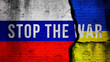 Stop the War text, war in Ukraine concept background. National flags and cracked brick wall image