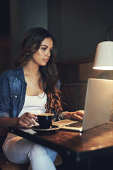 Poster - Sometimes you just need to get out of the office. Shot of a relaxed young woman using her laptop in a coffee shop.