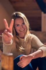 Poster - Peace is a mindset. Portrait of a young woman giving a peace sign while relaxing in her bedroom at home.