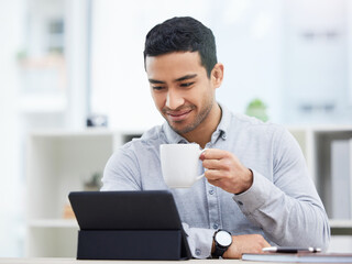 Poster - I guess I have interesting day ahead of me. Shot of a young businessman drinking coffee while using his digital tablet.