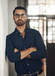 © N Felix/peopleimages.com - You have to stay dedicated to your dream. Portrait of a confident young businessman standing with his arms crossed in an office.