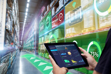 Smart Augmented Reality,AR Warehouse Management System.Worker Hands Holding Tablet On Blurred Warehouse As Background