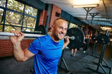 Sticker - Keep calm and build muscles. Shot of a man doing weight training at the gym.