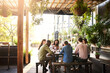 © Ruan Jordaan/peopleimages.com - Theyre working out in the fresh air today. Shot of a group of designers having a meeting at a coffee shop.