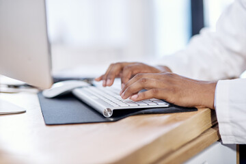 Wall Mural - typing up a few more patient reports. closeup shot of an unrecognisable doctor working on a computer