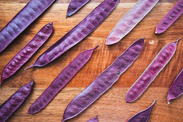 Wall Mural - Purple Guaje seed pods are arranged in a pattern on a table.