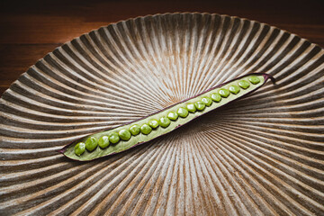 Wall Mural - Open Guaje seed pod on a plate with edible seed in Oaxaca, Mexico.