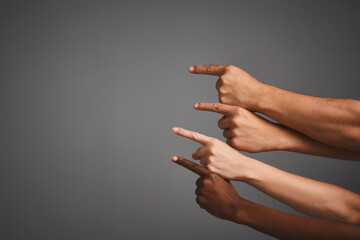 Poster - Pointing out some prime copyspace. Studio shot of unidentifiable hands pointing upwards towards blank copyspace.