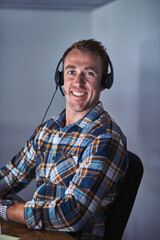 Fototapete - Hello, operator. Portrait of a happy customer service agent wearing a headset while sitting in the office.