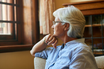 Sticker - The more you reflect, the more you realise. Cropped shot of a senior woman looking out the window at home.