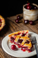 Wall Mural - piece of Delicious homemade classic cherry pie with a flaky crust on dark rustic background