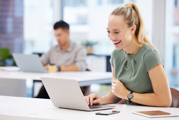Poster - I did it. Shot of an attractive young businesswoman sitting in the office and using her laptop.