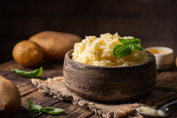 Wall Mural - Mashed potatoes in ceramic bowl on wooden rustic table. Healthy food