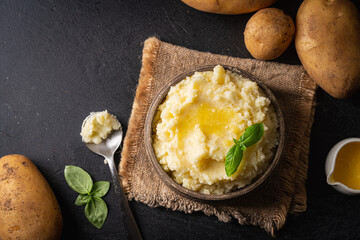 Wall Mural - Mashed potatoes in ceramic bowl on wooden rustic table, top view. Healthy food