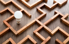 Light Bulb In The Maze Game Built By Wood Blocks, Finding The Right Way To The Success, Idea Concept