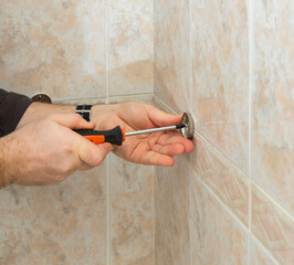 installation of fasteners for shelves in the bathroom, the concept of repair and construction