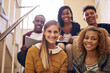 © Nikish H/peopleimages.com - This is what campus life is all about. Cropped portrait of a group of young university students sitting on their campus staircase.