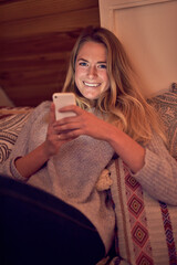 Poster - Im a social media master. Portrait of a young woman texting on her smartphone while relaxing in her bedroom at home.