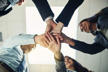 Come together and make it happen. Cropped shot of a group of businesspeople joining their hands in solidarity.