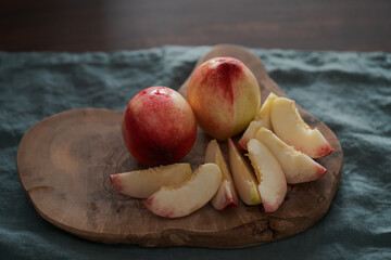 Wall Mural - ripe nectarines on wood board with natural lighting