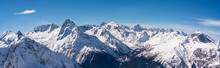 Panoramic View Of Winter Snowy Mountains In Caucasus Region In Russia With Blue Sky