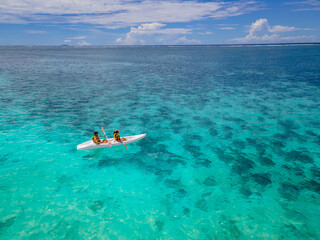 Mauritius vacation, couple man and woman in a kayak in a bleu ocean in Mauritius. 