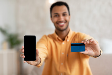 Poster - Excited man showing blank cellphone screen and credit card