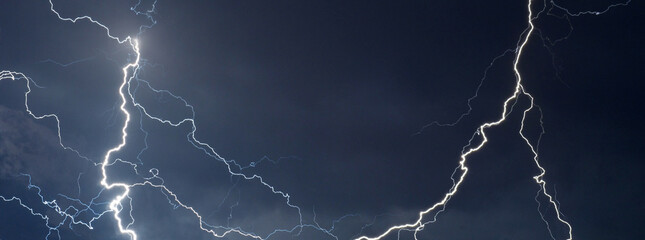 fork lightning striking down during summer storm