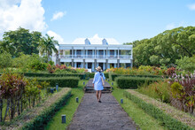 Le Chateau De Bel Ombre Mauritius, An Old Castle In A Tropical Garden In Mauritius.woman Walking In A Garden Of An Old Castle