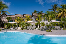 Tropical Pool With Beach Chairs And Umbrellas, Swimming Pool In Mauritius At A Sunny Day