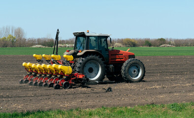 Sticker - Agricultural tractor with seeder machine at work on the field