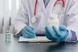 © Wasan - Doctor or medical scientist holding a bottle of medicine is writing down the formula and the results of a laboratory experiment.