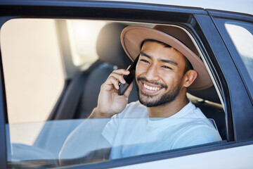 Canvas Print - The open road is a beckoning. Shot of a young man sitting in a car while using his phone.