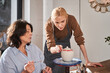 © Yakobchuk Olena - Skilful designer advising to her senior student while working at the pottery master class