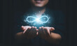 © Dilok - Hands holding virtual infinity with technology icon for symbol of connection to community metaverse world network system concept.
