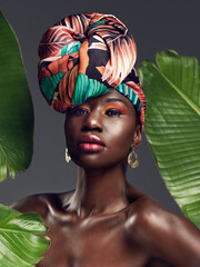 Sticker - More than just cloth, its my crown. Studio shot of a beautiful young woman wearing a traditional African head wrap against a leafy background.