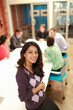 © Tetra Images - Portrait of young woman at office meeting