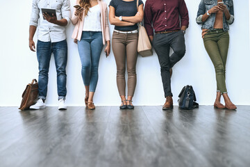 Canvas Print - Waiting for their chance. Shot of a group of diverse people waiting in line to be interviewed.