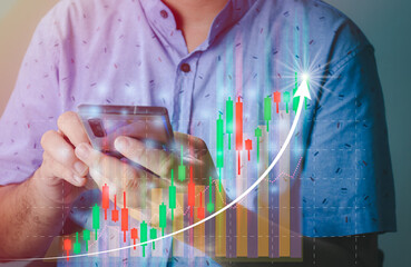 financial and investment technology concept,man's hand using smartphone to analyze graphs and charts of stock market digital assets gold and oil to be in line with the volatility of the world economy