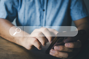 Wall Mural - The concept of using technology to search for information, a man's hand is using a smartphone to search for information on social media via the Internet online.
