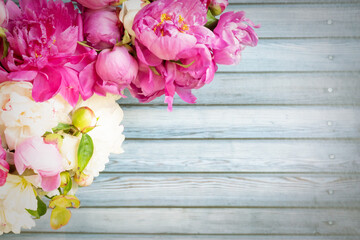 Wall Mural - border of beautiful pink and white peony flowers on wooden table with copy space for your text top v