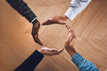 Poster - We are only as strong as we are united. High angle shot of a group of unidentifiable businesspeople forming a circle with their hands.