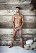 © Mr. Skin/peopleimages.com - How could masculinity get more masculine. Full length shot of a handsome young man holding a football while posing nude.