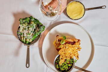 Assorted view of dinner table with delicious food set  for two, seafood,Salmon with broccoli, salad, club sandwich, salad with quinoa, tartar from beef